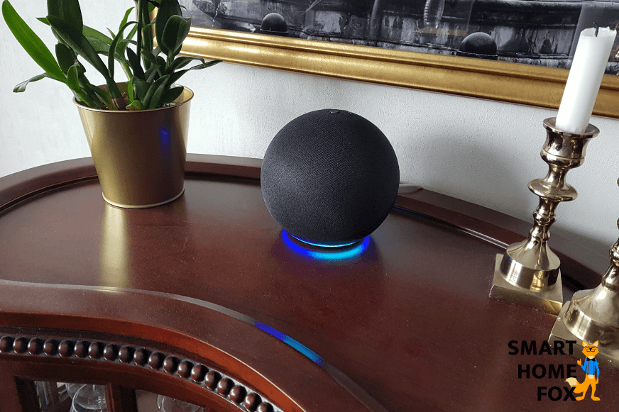 Alexa Echo stands on a table and the light ring glows blue